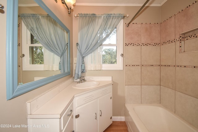 bathroom featuring hardwood / wood-style flooring, crown molding, and a wealth of natural light