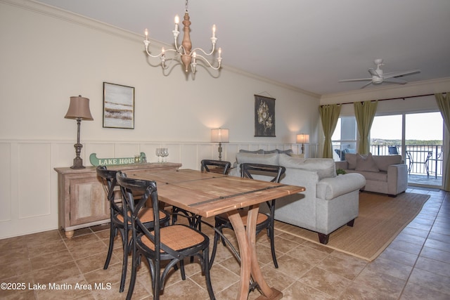 dining space featuring ceiling fan with notable chandelier and ornamental molding