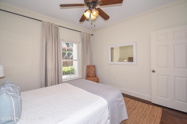 bedroom featuring crown molding, dark hardwood / wood-style floors, and ceiling fan