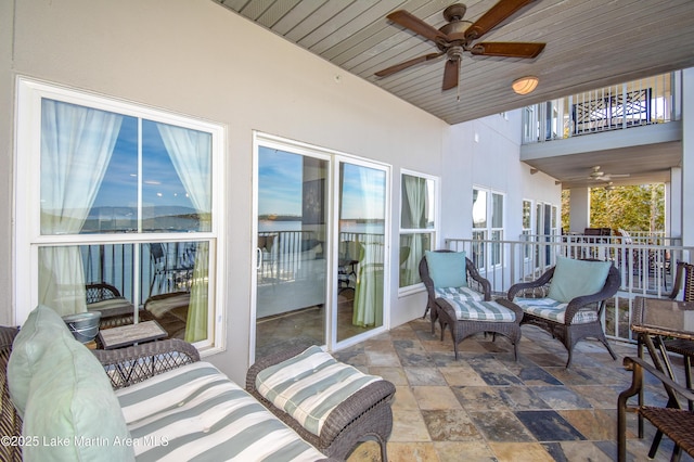 sunroom featuring ceiling fan and wood ceiling