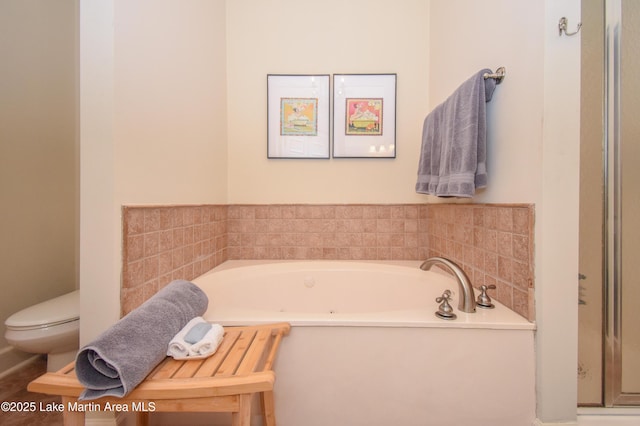 bathroom featuring a bath and toilet