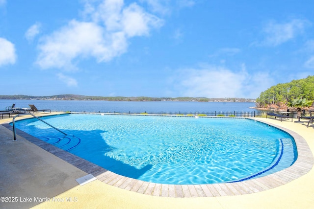 view of swimming pool with a water view