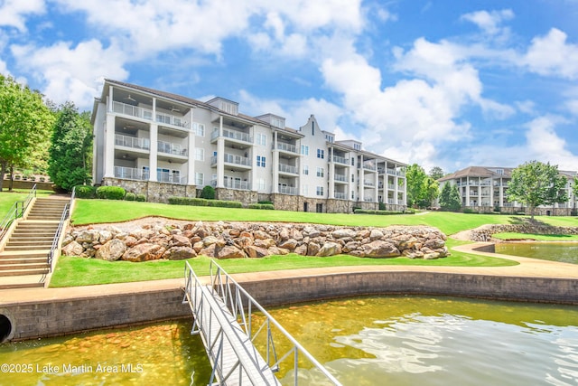 view of property's community featuring a water view and a lawn