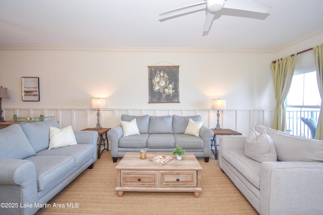 living room featuring crown molding and ceiling fan