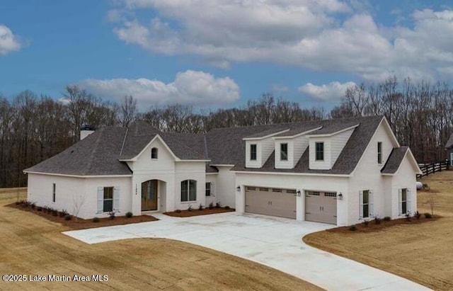 view of front of property with a garage and a front lawn