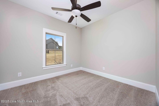 carpeted spare room featuring ceiling fan