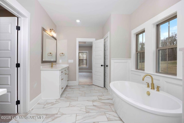 bathroom featuring vanity and a tub