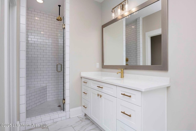 bathroom with a shower with door and vanity