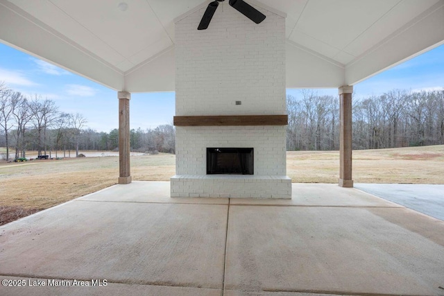 view of patio / terrace featuring an outdoor brick fireplace and ceiling fan