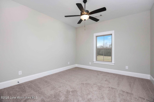 carpeted spare room featuring ceiling fan