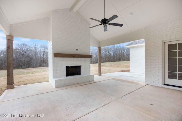 view of patio with an outdoor brick fireplace and ceiling fan