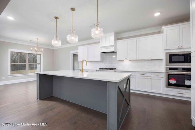 kitchen featuring hanging light fixtures, white cabinetry, and appliances with stainless steel finishes