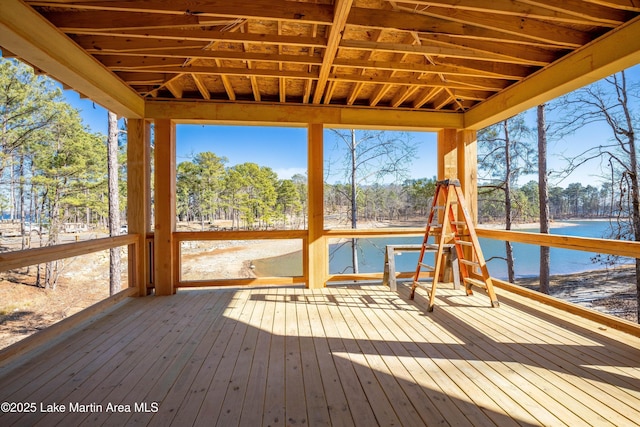 unfurnished sunroom featuring a water view