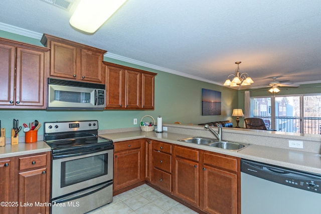 kitchen featuring sink, appliances with stainless steel finishes, ornamental molding, a textured ceiling, and light tile patterned flooring