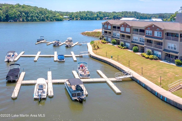 view of dock featuring a water view and a yard