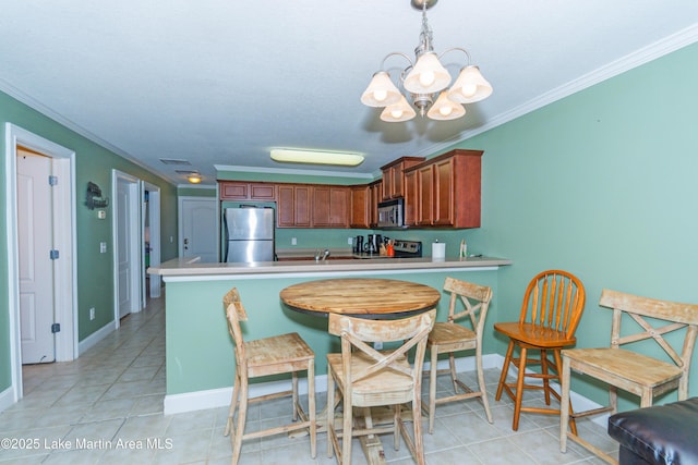 kitchen featuring light tile patterned floors, crown molding, appliances with stainless steel finishes, decorative light fixtures, and kitchen peninsula