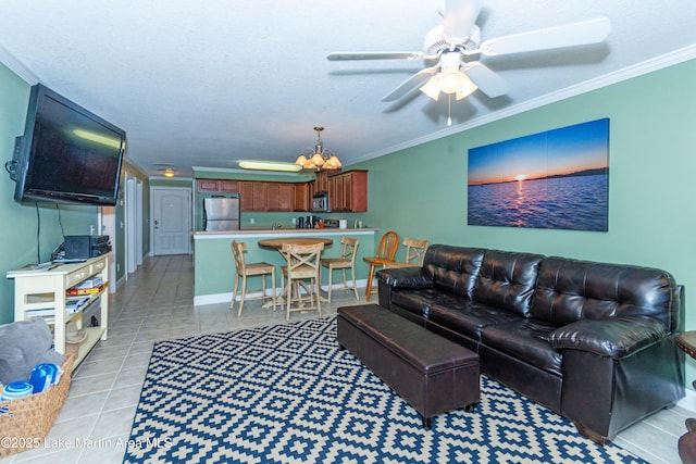 living room with light tile patterned flooring, ornamental molding, ceiling fan with notable chandelier, and a textured ceiling