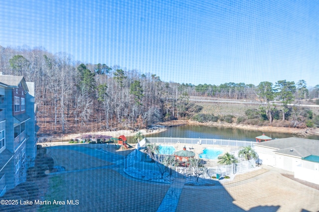 view of pool featuring a water view