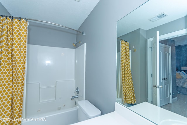 full bathroom with vanity, shower / tub combo, a textured ceiling, and toilet