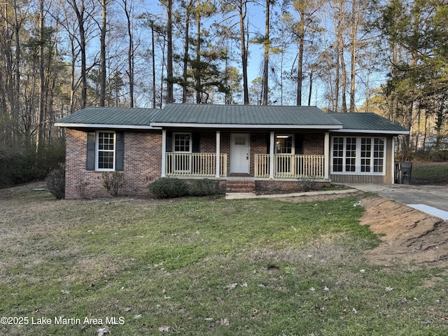 ranch-style house with covered porch and a front lawn