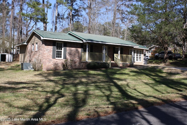 single story home with a porch, brick siding, metal roof, and a front lawn