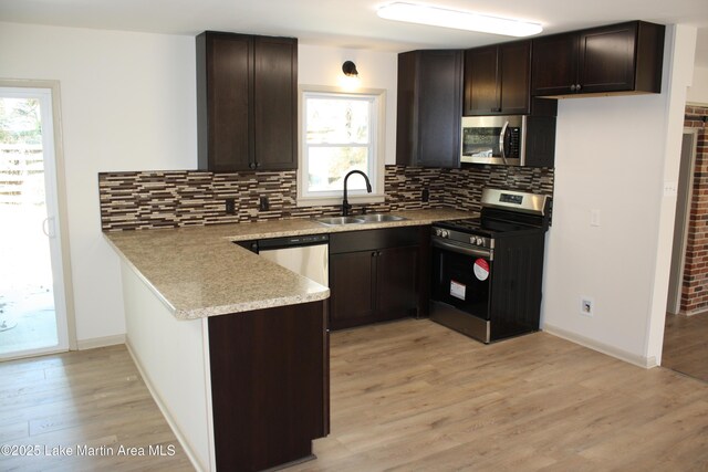 washroom with hardwood / wood-style floors, hookup for a washing machine, and electric panel