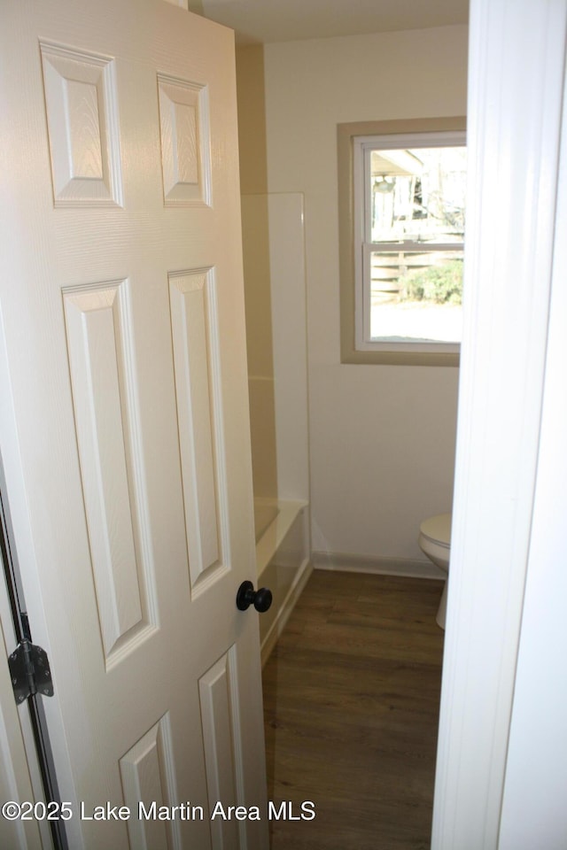 full bathroom with wood finished floors and toilet