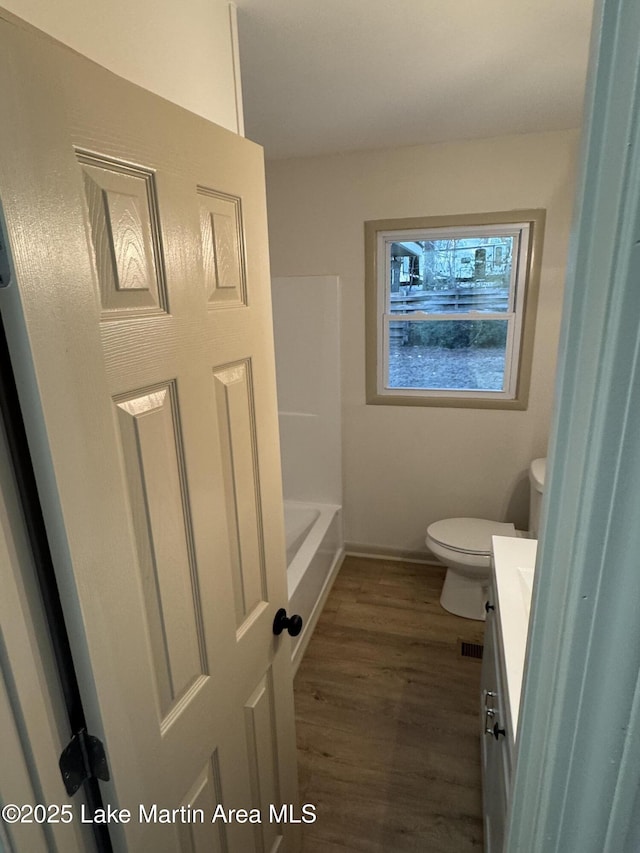 bathroom featuring hardwood / wood-style flooring, vanity, and toilet