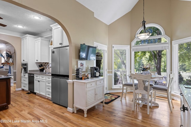 kitchen featuring stainless steel fridge, light wood-type flooring, pendant lighting, high vaulted ceiling, and white cabinetry