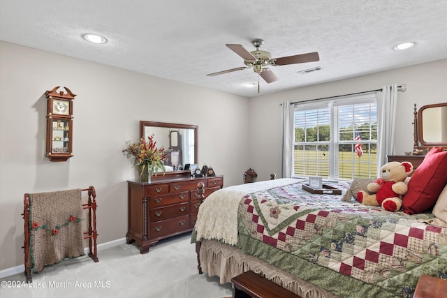 carpeted bedroom with a textured ceiling and ceiling fan