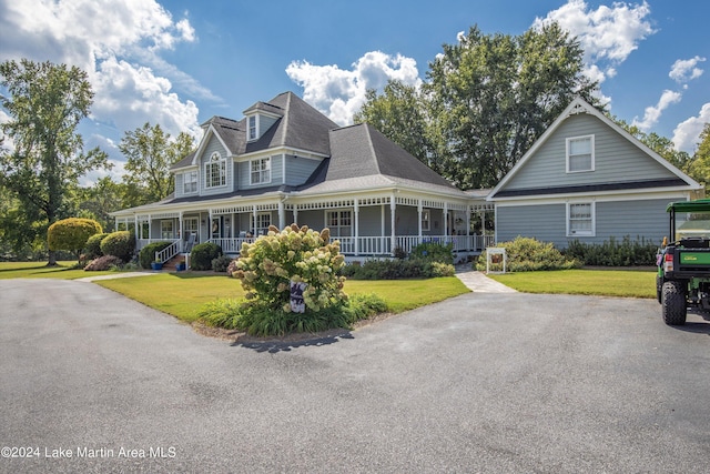 view of front of house with a porch and a front lawn