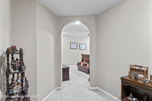 hallway featuring light colored carpet