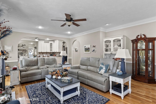 living room with ceiling fan, light hardwood / wood-style floors, and crown molding