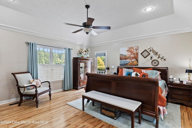 bedroom with light hardwood / wood-style floors, multiple windows, ornamental molding, and ceiling fan