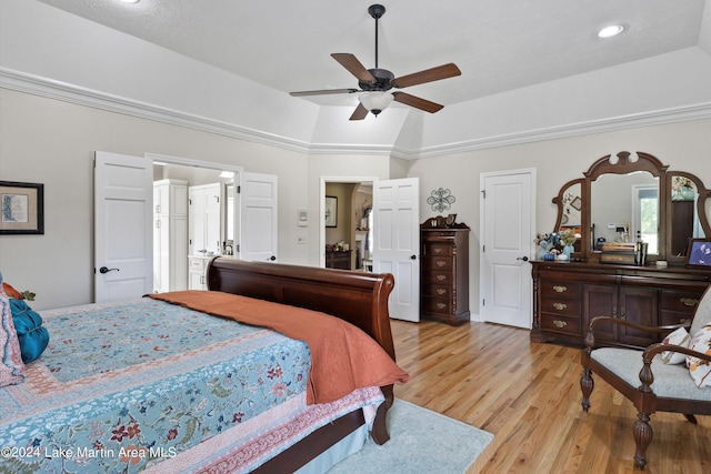 bedroom featuring ceiling fan, crown molding, light hardwood / wood-style flooring, and vaulted ceiling