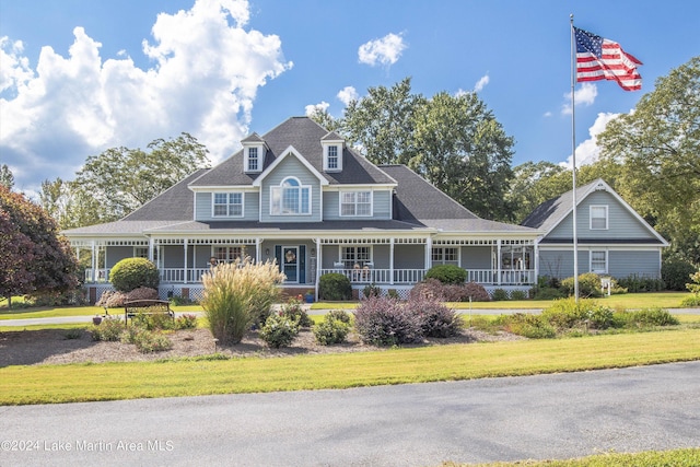 view of front of house featuring covered porch and a front yard