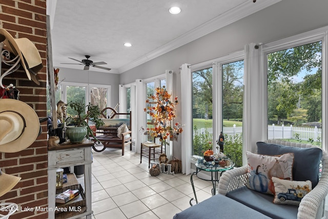 sunroom featuring ceiling fan and a healthy amount of sunlight