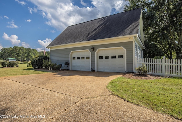 garage featuring a lawn