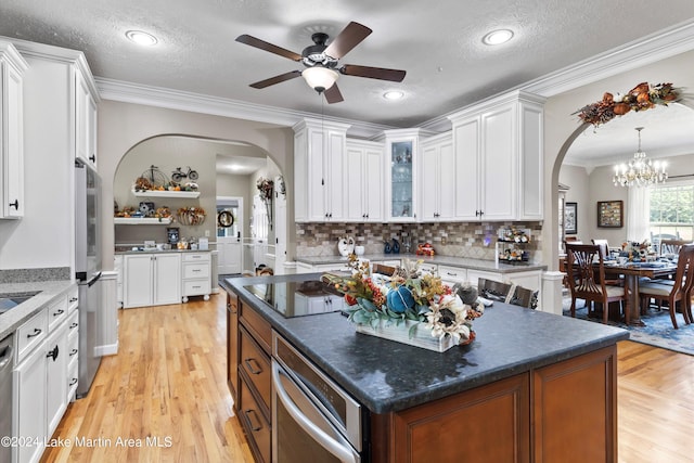 kitchen with a center island, light hardwood / wood-style flooring, and white cabinets