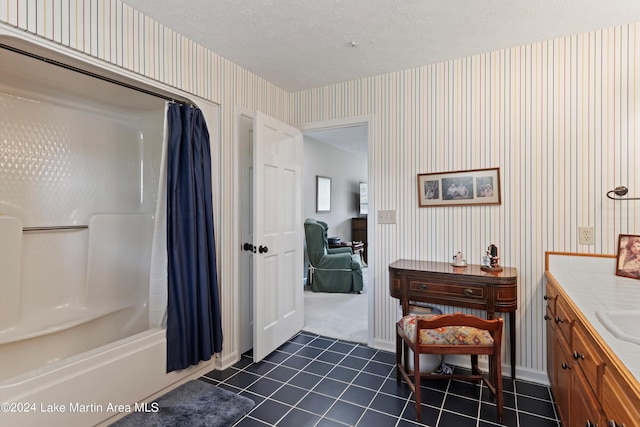 bathroom with tile patterned floors, shower / bath combination with curtain, a textured ceiling, and vanity