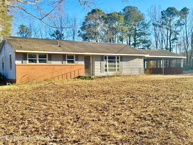 view of front of home with an attached carport and brick siding