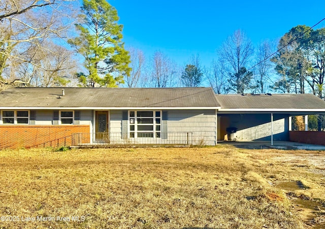 back of property featuring an attached carport