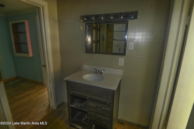 bathroom with vanity, tile walls, and hardwood / wood-style flooring