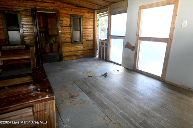 interior space featuring wood walls and wood-type flooring