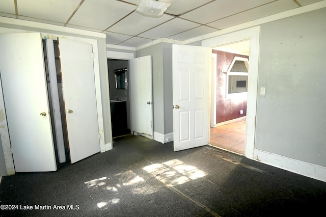 unfurnished bedroom with a drop ceiling