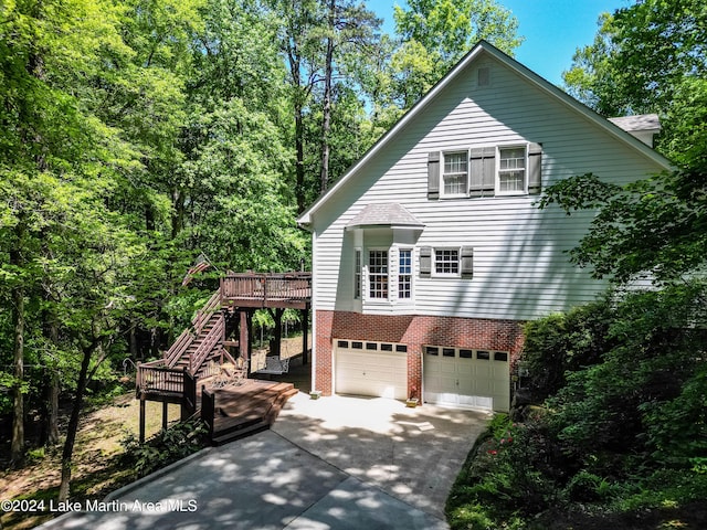 view of front facade with a garage and a wooden deck