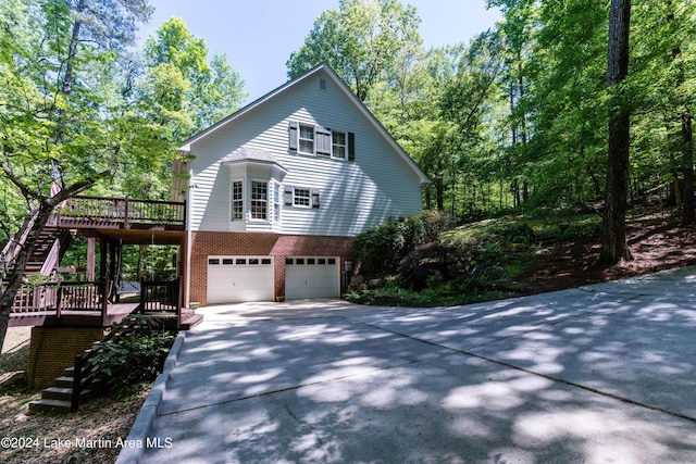 view of front of home with a garage and a wooden deck