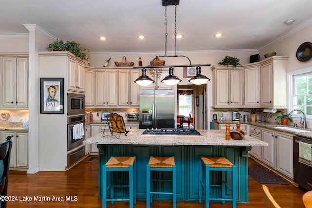 kitchen featuring a kitchen breakfast bar, light stone counters, a kitchen island, and stainless steel appliances