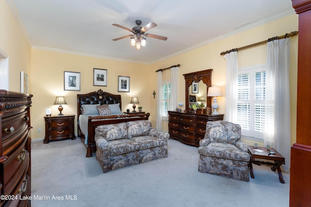 carpeted bedroom featuring ceiling fan and crown molding