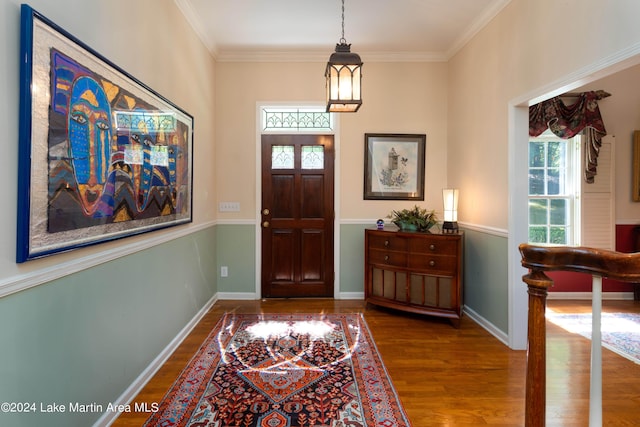 foyer entrance with wood-type flooring and ornamental molding